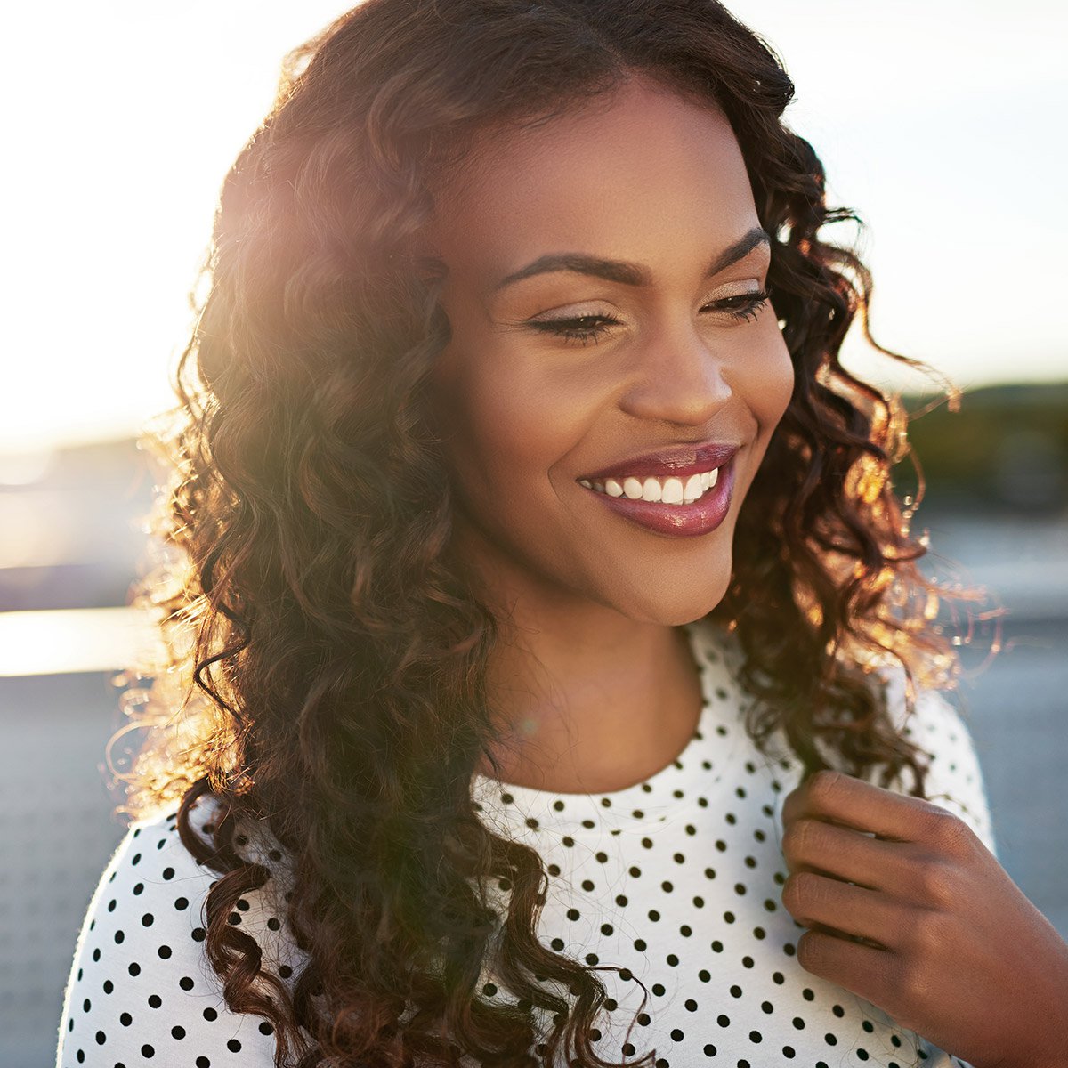 sculptra butt lift patient model smiling at a beach