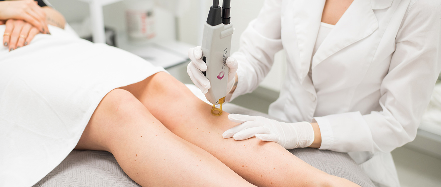 laser hair removal patient model sitting in her bed smiling